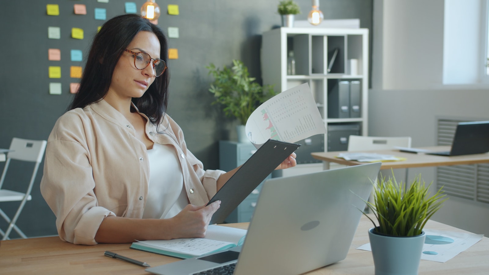 A business owner working through paperwork and admin tasks at her desk